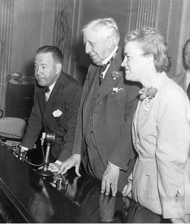 Herbert O'Connor, Clyde Hoey, and Margaret Chase Smith. They are standing at a table. Connor and Smith are both middle-aged, while Hoey is significantly older. 