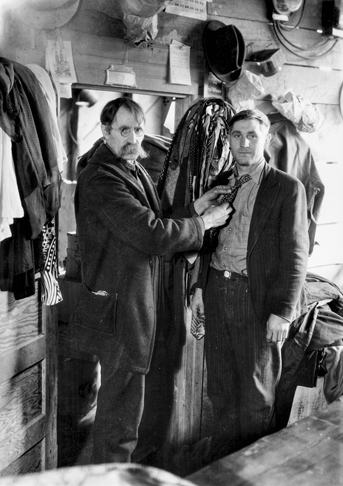 Man being fitted with used clothes at the “ongoing yard sale” sponsored by Crossnore School as a way to raise money. Photograph by Bayard Wootten. North Carolina Collection, University of North Carolina at Chapel Hill Library.